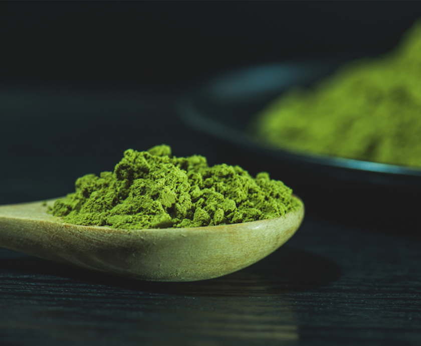 matcha in a private label tin with a white spoon